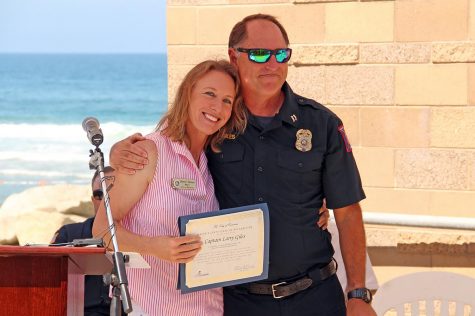 Encinitas Mayor Catherine Blakespear stands with city Marine Safety Capt. Larry Giles at his retirement celebration Tuesday, July 20, at Moonlight Beach. (Photo courtesy of Scott Chatfield)