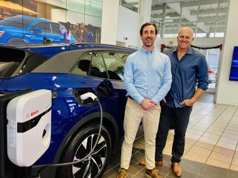 Herman Cook Volkswagen General Manager and co-owner Connor Cook and Stellar Solar CEO Kent Harle stand with the new VW ID.4 Electric Vehicle and Bosch Power Max EV Charger, soon to be powered by Stellar Solar’s 65-kilowatt solar system. (Courtesy photo)