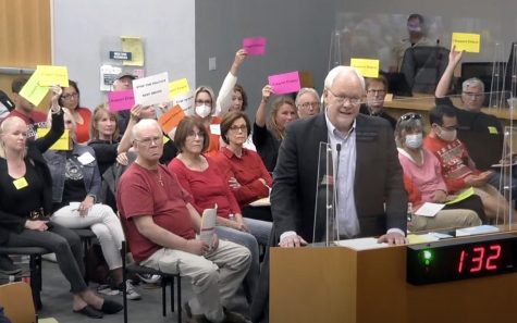 Former Encinitas Planning Commission Chairman Bruce Ehlers, with supporters behind him, addresses the City Council on Wednesday, April 13, ahead of the council’s vote to remove him from the commission. (Encinitas city video feed)
