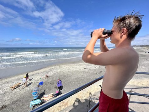 Encinitas lifeguard Jake Ratermann, founder of Project Moonlight, keeps watch over the beach in Cardiff on April 16. (Photo courtesy of William Roland)