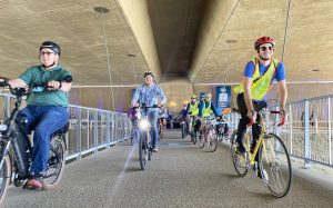 Encinitas Councilman Jerry Kranz (far left) participates in an inaugural bike ride across the San Elijo Lagoon Ecological Reserve’s new pedestrian suspension bridge on Saturday, June 4. (SANDAG social media photo)