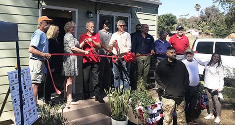Representatives from groups including Warrior Village Project and Wounded Warrior Homes stand in front of an accessory dwelling unit at a ribbon-cutting ceremony on June 23, 2021. (Warrior Village Project photo)