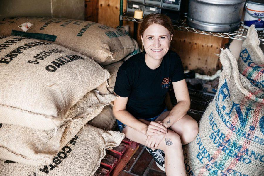 Old Cal Coffee Co. co-owner Erin Nenow sits among bags of beans she uses for her new Ascend Coffee Roasters business on Aug. 24. (Photo by Jen Acosta)