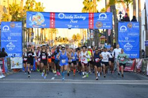 Runners leave the starting line Nov. 24 at the annual O’side Turkey Trot in Oceanside. (Event photo by Rich Cruse)