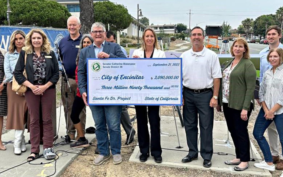 California state Sen. Catherine Blakespear (center) and Encinitas Mayor Tony Kranz (immediate left) stand with members of the Encinitas City Council, San Dieguito High School Academy and family of Brodee Braxton Champlain-Kingman on Sept. 21 as they mark the granting of $3.09 million in state funds for the Santa Fe Drive Corridor Improvements Project. (Encinitas city photo)