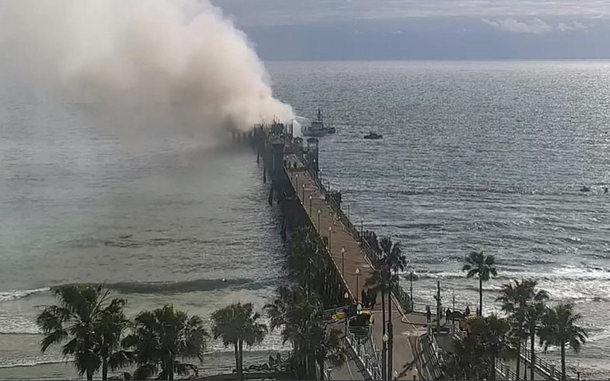 Crews work to stop a fire at the end of the Oceanside Pier on Thursday, April 25. (SurfOutlook photo via the city of Oceanside)