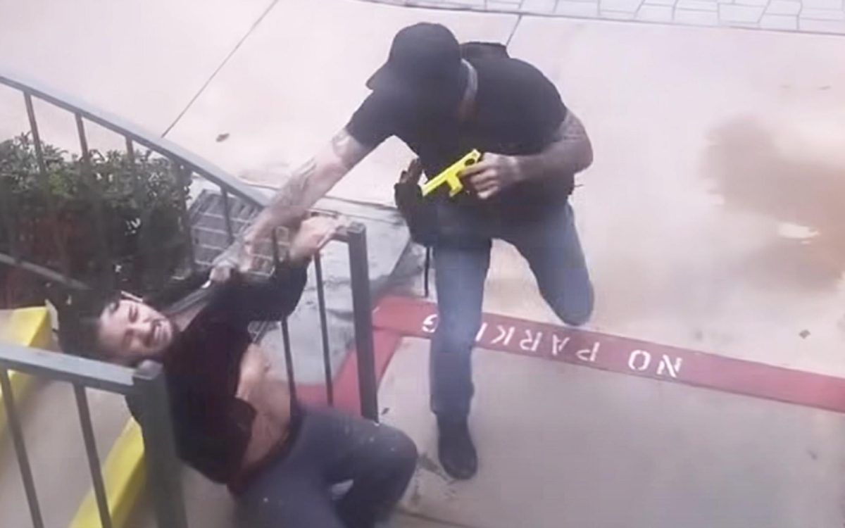 A screen capture from social media video, which was also shared during open comments at a recent Encinitas City Council meeting, shows a man being detained by an agent at an apartment complex near Quail Gardens Drive on Oct. 15 in Encinitas. (Social media image)