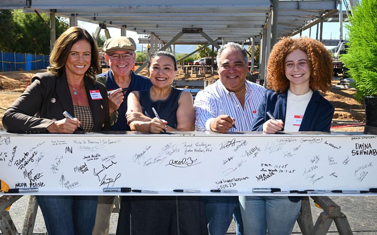 Left to right: Palomar College Governing Board President Jacqueline Kaiser, Trustee Emeritus Mark Evilsizer, Superintendent/President Star Rivera-Lacey, Trustee Roberto Rodriguez and Student Trustee Ariel Fridman sign a beam of the community college’s new Fallbrook campus building on Oct. 10. (Palomar College photo)