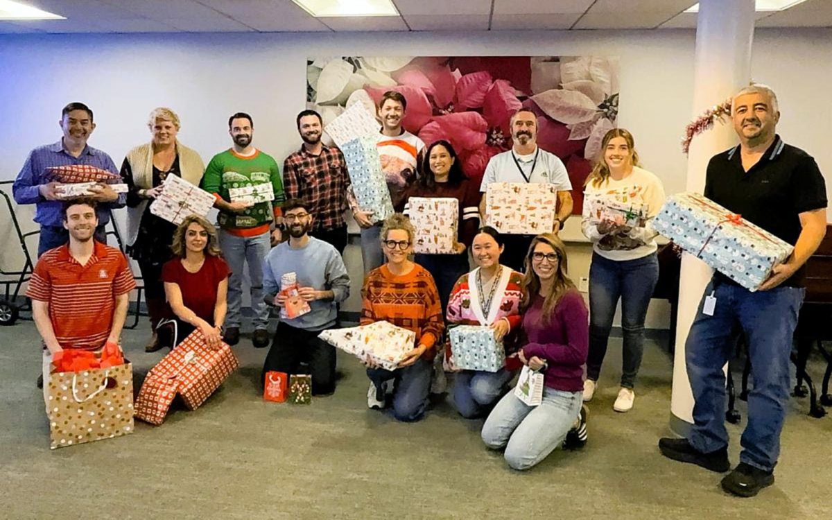 Members of the Encinitas city Engineering Department show wrapped gifts for a family that the division adopted as part of a Boys & Girls Clubs program. (Encinitas Engineering Department photo)