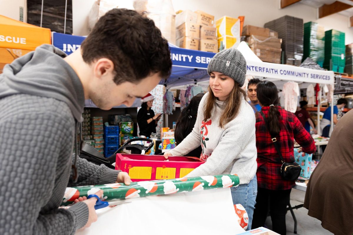 Interfaith Community Services volunteers wrap gifts for the nonprofit organization’s Holiday Sponsor-A-Family program Dec. 13 in Escondido. (Interfaith Community Services)