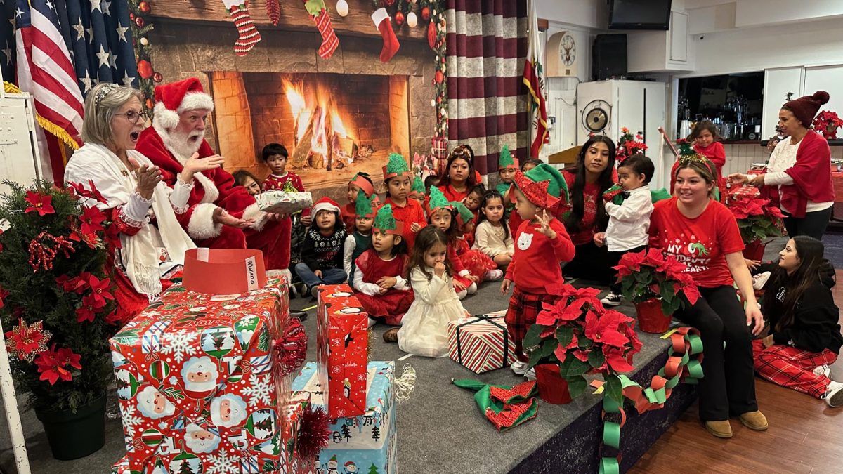 Preschoolers from the Children’s Atelier enjoy a visit with Santa and Mrs. Claus during the annual Encinitas Rotary holiday celebration at the Elks Lodge. (Encinitas Rotary photo by Kyle Thomas)