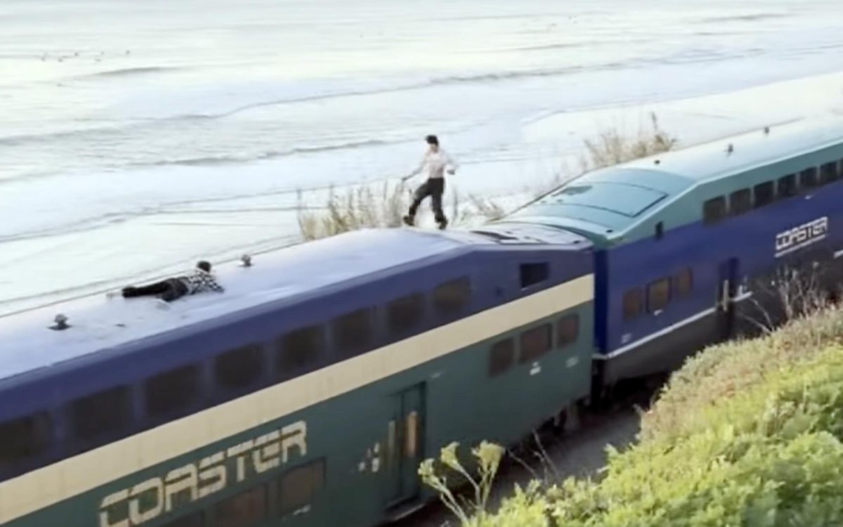 A screen capture from video circulated on social media Jan. 9 shows two people riding on top of a Coaster commuter train through Del Mar. (Instagram video credited to TJ Wilcox)