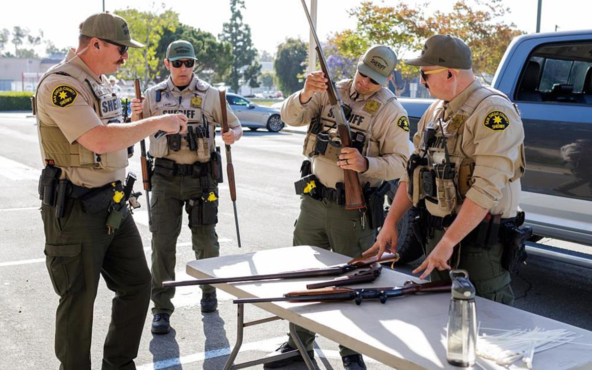 San Diego County Sheriff’s Office deputies inspect returned firearms during a gun safety event April 18 at the San Marcos Sheriff’s Station. (Sheriff’s Office photo)