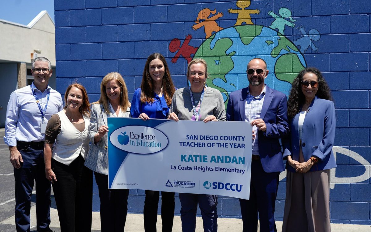 La Costa Heights Elementary School teacher Katie Andan (center, wearing gray) celebrates her San Diego County Teacher of the Year award on May 14 with school district, county Office of Education and San Diego County Credit Union officials. (Photo by Alejandro Tamayo, San Diego County Office of Education)