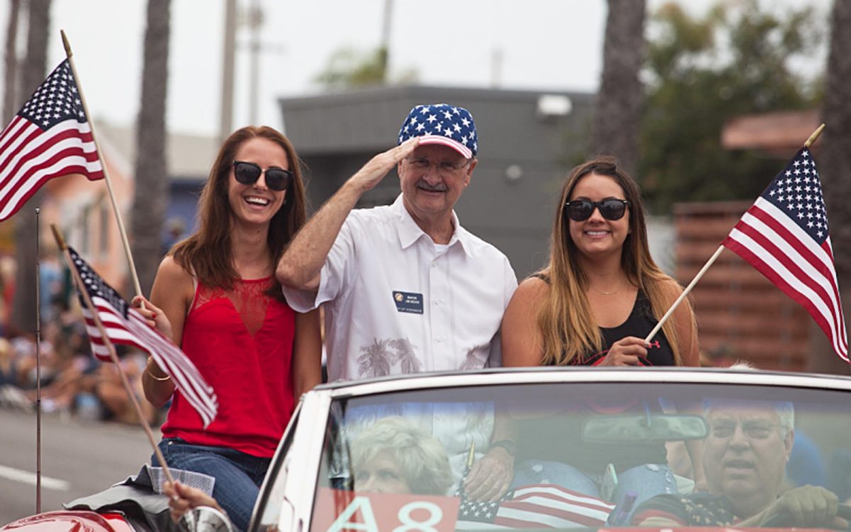 Former Oceanside Mayor Jim Wood salutes during the city’s 2016 Independence Parade, in which he served as grand marshal. (OsideNews file photo by Steve Marcotte)