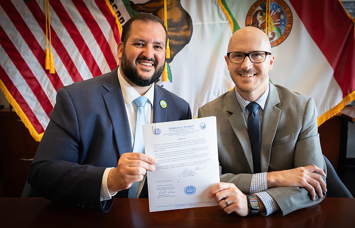 San Diego County Assessor-Recorder-County Clerk Jordan Z. Marks (left) and county Board of Supervisors Executive Officer/Clerk Andrew Potter note the completion of this year’s tax roll assessment. (Courtesy photo)